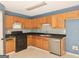 Kitchen featuring stainless steel appliances, tile floor, wooden cabinets, and dark countertops at 89 Farm Brook Ln # 17, Dallas, GA 30157