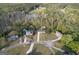 Wide aerial view of a neighborhood with houses, mature trees, and a small pond, blending nature with residential living at 237 Summerford Pl, Stockbridge, GA 30281