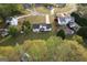 Aerial neighborhood view featuring green lawns, mature trees and a glimpse of a home with a private pool at 237 Summerford Pl, Stockbridge, GA 30281