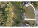 Neighborhood aerial view with lush trees, a stream and a glimpse of a home with a private pool at 237 Summerford Pl, Stockbridge, GA 30281