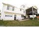 Two-story home with a screened porch and backyard with a garage and a covered outdoor seating area at 237 Summerford Pl, Stockbridge, GA 30281