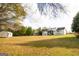 Large backyard with outbuildings and mature trees, offering plenty of space for outdoor activities at 237 Summerford Pl, Stockbridge, GA 30281