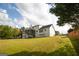Well-maintained backyard features a spacious lawn and a charming two-story home, perfect for outdoor activities at 237 Summerford Pl, Stockbridge, GA 30281