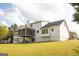 Backyard showing two-story home with a screened porch, well-maintained lawn, and ample space for outdoor activities at 237 Summerford Pl, Stockbridge, GA 30281