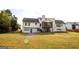 Expansive backyard featuring a screened-in porch, large lawn, and attached garage at 237 Summerford Pl, Stockbridge, GA 30281