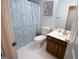 Cozy bathroom featuring a vanity with cabinets, a toilet, and a patterned shower curtain at 237 Summerford Pl, Stockbridge, GA 30281