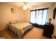 Comfortable bedroom featuring a ceiling fan, neutral carpet, and a window with drapes at 237 Summerford Pl, Stockbridge, GA 30281
