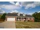 Charming, single-story brick home featuring a two-car garage and dormer windows at 237 Summerford Pl, Stockbridge, GA 30281
