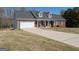 Charming single-story brick home with a well-manicured lawn and two-car garage at 237 Summerford Pl, Stockbridge, GA 30281