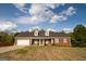 Charming, single-story brick home featuring a two-car garage and dormer windows at 237 Summerford Pl, Stockbridge, GA 30281