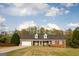 Charming, single-story brick home featuring a two-car garage and dormer windows at 237 Summerford Pl, Stockbridge, GA 30281