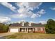 Charming, single-story brick home featuring a two-car garage and dormer windows at 237 Summerford Pl, Stockbridge, GA 30281