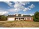 Charming, single-story brick home featuring a two-car garage and dormer windows at 237 Summerford Pl, Stockbridge, GA 30281