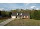Aerial view of a brick home with a well-maintained lawn, two-car garage, and inviting front porch at 237 Summerford Pl, Stockbridge, GA 30281