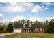 Charming, single-story brick home featuring a two-car garage and dormer windows at 237 Summerford Pl, Stockbridge, GA 30281
