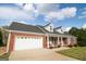 Charming, single-story brick home featuring a two-car garage and dormer windows at 237 Summerford Pl, Stockbridge, GA 30281