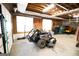 This spacious garage features a lawn mower, tool organizers, and ample natural light from the windows at 237 Summerford Pl, Stockbridge, GA 30281