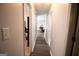 A long hallway with neutral paint and wood floors connects various rooms in the house at 237 Summerford Pl, Stockbridge, GA 30281