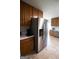 A kitchen with stainless steel refrigerator and oak cabinets for ample storage space at 237 Summerford Pl, Stockbridge, GA 30281