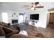 Bright living room features a fireplace, modern flooring, and ceiling fan at 237 Summerford Pl, Stockbridge, GA 30281