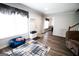 Charming living room with a cozy couch, area rug, hardwood floors, and ample natural light at 237 Summerford Pl, Stockbridge, GA 30281