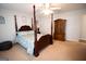 Spacious main bedroom boasts a four-poster bed, dresser, and ample natural light at 237 Summerford Pl, Stockbridge, GA 30281