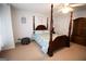 Well-lit main bedroom with carpet, four-poster bed, and complementary furniture at 237 Summerford Pl, Stockbridge, GA 30281