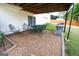 Covered patio with gravel floor, outdoor seating, and a grill, creating a cozy and inviting outdoor space at 237 Summerford Pl, Stockbridge, GA 30281