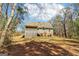 Expansive backyard featuring a two-story home with a screened-in porch and mature trees providing shade at 375 Wellington Mill Rd, Whitesburg, GA 30185