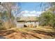 Lush backyard with a two-story home featuring a screened-in porch and mature trees surrounding the property at 375 Wellington Mill Rd, Whitesburg, GA 30185