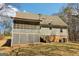 Backyard view of a large two-story home featuring a screened-in porch with stairs leading down to the yard at 375 Wellington Mill Rd, Whitesburg, GA 30185