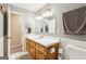 Bathroom featuring a white vanity, mirror, and wainscotting on the wall at 375 Wellington Mill Rd, Whitesburg, GA 30185