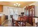 Bright dining room features a classic wood table set, hardwood floors, and natural light at 375 Wellington Mill Rd, Whitesburg, GA 30185