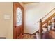 Welcoming entryway featuring a decorative glass door and staircase with wood trim at 375 Wellington Mill Rd, Whitesburg, GA 30185