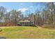Scenic view of a charming home surrounded by lush greenery and mature trees at 375 Wellington Mill Rd, Whitesburg, GA 30185