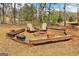 Fire pit in the back yard with chairs and wood trim at 375 Wellington Mill Rd, Whitesburg, GA 30185