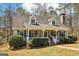 Charming home featuring a cozy front porch, dormer windows, and landscaped yard, creating a welcoming curb appeal at 375 Wellington Mill Rd, Whitesburg, GA 30185