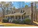 Charming home featuring a cozy front porch, dormer windows, and landscaped yard at 375 Wellington Mill Rd, Whitesburg, GA 30185