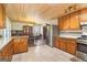 Bright kitchen features granite countertops, stainless steel appliances, and wood plank ceilings at 375 Wellington Mill Rd, Whitesburg, GA 30185