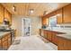 Kitchen featuring wooden cabinets, stainless steel appliances, with access to the laundry room at 375 Wellington Mill Rd, Whitesburg, GA 30185