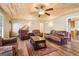 Cozy living room featuring a wood plank ceiling, ceiling fan, and matching leather furniture at 375 Wellington Mill Rd, Whitesburg, GA 30185