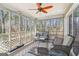 Enclosed sunroom with comfortable seating, offering a relaxing space with natural light and serene backyard views at 375 Wellington Mill Rd, Whitesburg, GA 30185