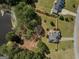 Aerial view of a fenced property with a deck, mature trees, and proximity to a serene pond at 720 Strawflower Ln, Locust Grove, GA 30248