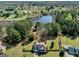 Expansive aerial view showcases a beautiful home, lush landscaping, and a serene lake view within a charming community at 720 Strawflower Ln, Locust Grove, GA 30248