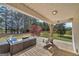 Cozy back porch with outdoor seating, swing, string lights, and views of the backyard at 720 Strawflower Ln, Locust Grove, GA 30248