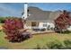 Backyard featuring a spacious deck with outdoor seating, perfect for entertaining, and a lush lawn area at 720 Strawflower Ln, Locust Grove, GA 30248