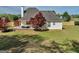 Backyard featuring a spacious deck with outdoor furniture, perfect for entertaining, complemented by a lush lawn at 720 Strawflower Ln, Locust Grove, GA 30248