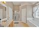 This bathroom is finished with double sink vanity, a walk-in shower, and large soaking tub at 720 Strawflower Ln, Locust Grove, GA 30248