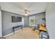 Bedroom with TV, desk and a window with natural light at 720 Strawflower Ln, Locust Grove, GA 30248