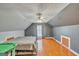 Large bedroom with ceiling fan, hardwood floors, and dormer windows at 720 Strawflower Ln, Locust Grove, GA 30248